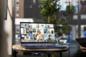 Manager using laptop, discussing with collaborators working from home in online teleconference, checking progress done on project. Man with workers in online remote videocall doing business audit photo