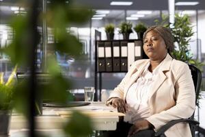 CEO setting goals for performance and growth, evaluating performance by analyzing and interpreting data metrics. Manager ensuring compliance with legal, regulatory and safety standards photo