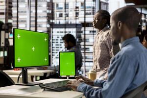 African American businessman at office with mockup screen analyzing financial data and developing growth strategies to achieve company success. Analyst managing important tasks. photo