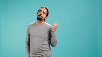 Cheerful man acting casually, exuding nonchalant and carefree demeanor. Portrait of jolly person being relaxed and at ease, showing self assuredness, studio background, camera B photo