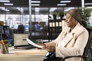 Businesswoman holding teleconference meeting with HR, liaising to recruit, train and guide staff. Team leader instructing human resources worker in online remote videocall using tablet photo