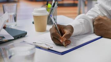 Job candidate signing his work contract and securing a corporate position, reading the employment agreement terms. Businessman applicant finding a new job within company. Close up. Camera A. photo