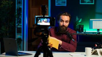 Online show host reading and recommending best reviewed books of the year. Content creator in studio doing novel summaries for interested readers, speaking in professional mic, camera A photo