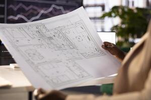 Architectural designer responsible for designing buildings for client drawing up building plans and modifying designs throughout the building process to maximize structural integrity photo