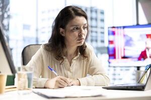 Determined entrepreneur handles the paperwork for global enterprise and signing contracts, reading legal documents to give her authorization for business management. Executive power. photo
