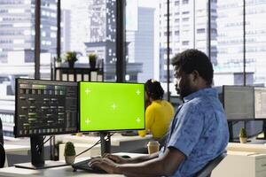 Programmer using mockup PC to develop machine learning APIs solving complex problems. Man training predictive models capable of handling complex tasks using isolated screen computer photo