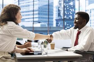 HR expert doing handshake with person with disability, vetting applicants to ensure skills match role needs. Headhunter talking with man in wheelchair, shaking hands after assessing work experience photo