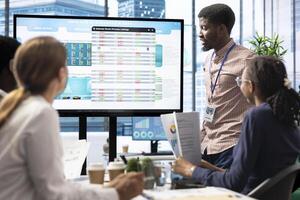 Company workers in a high end office space collaborating on project management tasks, utilizing digital tools to enhance workflow and productivity. Reviewing big data on interactive board. photo
