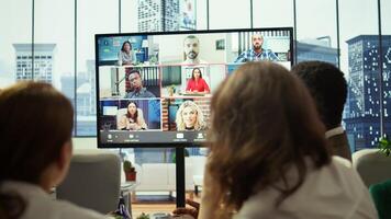 General manager starts a meeting on online videoconference call in the boardroom, discussing about updates with his staff. Business associates reviewing financial planning for growth. Camera B. photo