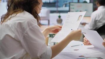 Team of recruiters working together to choose the right applicant with the best qualifications to fill in the vacancy. HR experts selecting candidates based on their resume, job offer. Camera A. photo