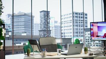 Empty modern corporate high end office space designed for a CEO or person with authority, running analytics and reports on screen. Urban global enterprise workspace, empowerment. photo