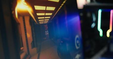 Computer screen showing FPS videogame with futuristic weapon shooting laser bullets at flying robots. Extreme close up of POV shooting videogame on PC in living room with no people in photo