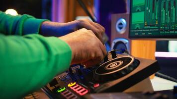 Audio engineer with headset mixing and mastering his recorded files, operating on a professional soundboard in home studio. Artist producer composing new tracks with sound effects. Camera B. photo