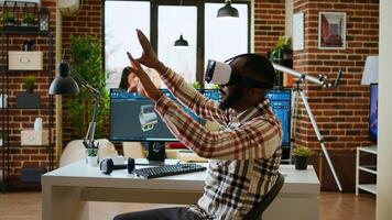 African american software developer working with virtual reality headset and artificial intelligence to create new industrial prototypes and manufacturing tools on CAD software. Camera A. photo