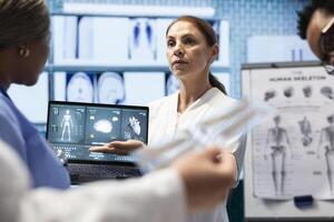Radiologists doctors analyzing cardiology scans to detect heart conditions, developing effective treatment strategy. Working on electrocardiogram test results, healthcare industry. photo