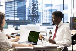 HR employee using isolated screen laptop to determine if candidate possesses skills needed to fulfil role. HR manager using mockup notebook to evaluate if applicant qualifications align with company photo