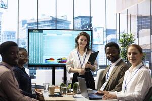Employees team analyzing infographics to offer solutions for the new project, looking to finish tasks before deadline. Enterprise coworkers attending problem solving conference in boardroom. photo