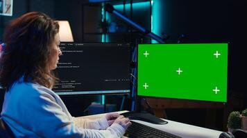 Cybersecurity expert uses green screen computer to look for security vulnerabilities and injected malware, close up. Admin installing fortified code on chroma key PC to prevent cyber attacks, camera B photo