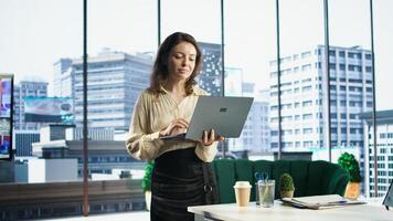 Ambitious woman director oversees a strategic review of the enterprise activity, analyzing market trends and setting new priorities. Ensuring the company objectives achievements. Camera A. photo