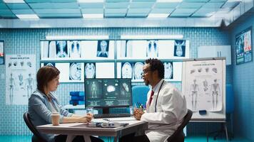General practitioner giving the right diagnosis to woman patient, attending a checkup consultation in medical cabinet. Doctor explaining x ray imaging and scan results, care management. Camera B. photo