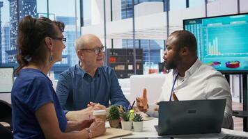 Senior couple consulting with a professional financial advisor in a modern office to discuss comprehensive retirement plans. Planning investments with life savings and pension options. Camera B. photo