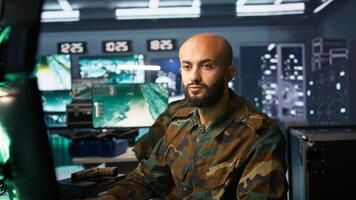 Army telecommunication systems operator using radio and satellite gear to gather intel, providing combat support. Special forces military dispatcher managing communications networks, camera B photo