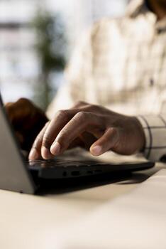 Successful entrepreneur working on financial forecasts at his desk, using data and technology to manage business tasks and project development. Company progresses toward its goals. Close up. photo