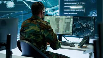 Soldiers in a modern command center analyze live data from cctv radar sources, satellite feeds and surveillance systems. Intelligence to support strategic planning and military operations. Camera A. photo
