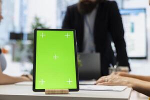Focus on isolated screen tablet used by advisor to show clients stock market trends. Close up of broker using mockup device to offer family tailored strategies to identify investment opportunities photo