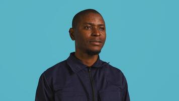 Headshot portrait of african american security agent isolated against colored studio background. Close up shot of guardian securing assigned post standing over studio backdrop, camera B photo