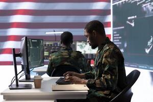 Team of military personnel manages surveillance and security operations from a high tech command center, ensuring data protection and national security with surveillance imagery. photo