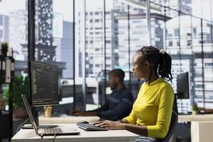 IT worker coding in programming languages to construct algorithms and build applications. Software engineer developing and maintaining databases and data structures in office photo