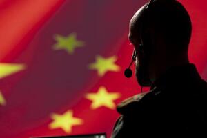 Military dispatcher working for Chinese Communist Party providing informations for troops using headset. Radio communications operator isolated over China flag background coordinating troops photo