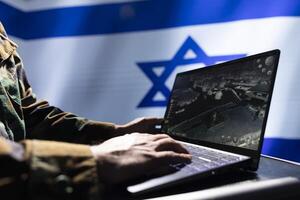 Israel Defense Forces expert analyzing aerial reconnaissance data to come up with global conflict winning strategy. IDF operative in command room controlling drones attacking strategic targets photo