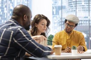 Businesswoman sharing her vision and discussing about concerns regarding the lease on high class office space. Collaborating with real estate brokers experts to strategize investment. photo