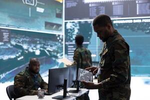 Military personnel in a control center working on data processing, integrating real time surveillance and maintaining security protocols essential for national defense and strategic operations. photo