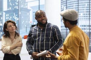 Entrepreneurs sharing their workspace vision with the broker, evaluating architectural blueprints for a new office space in high class urban building. Potential investment in property. photo