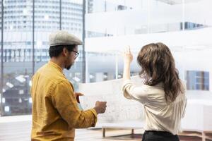 Business owner on an office tour with a realtor contractor, examining modern property layout before reaching an agreement. Evaluating urban office space in a high class building. photo