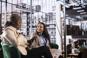 Multicultural group of businesswomen in a high powered meeting, promoting gender equality and female authority in a work environment. Leaders in a male dominated industry, enlightened world photo
