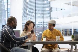 Real estate brokers meeting with client to reach an agreement for property leasing contract, evaluating urban property blueprints and negotiating terms for a high class corporate building. photo