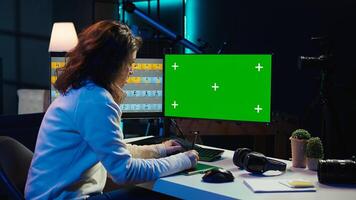 Photo editor working in independent production company using green screen monitor and graphic tablet. Photographer adjusting white balance on overexposed pictures on mockup desktop computer, camera B