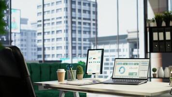 Modern corporate environment in an urban downtown building, high end workspace with business analytics and reports running on screen. Successful career development, office life. Camera B. photo