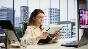 Corporate leader signing work contracts and agreements to approve leave requests and other documents for productivity. CEO businesswoman working on legal management, success story. Camera B. photo