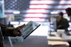 Military officers monitoring national safety operations from a high tech command post, managing surveillance data and ensuring security through advanced intelligence systems. Close up. photo