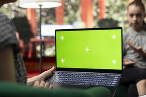 Therapist uses green screen display in a counseling session with an adolescent dealing with low confidence. Psychotherapist supports her in building resilience and self esteem. photo
