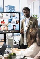 Diverse team of workers reviewing project updates together with shareholders on call online meeting, ensuring easy remote collaboration for global business expansion plans. Teamwork. photo