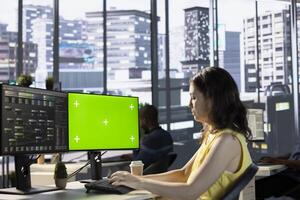 Admin utilizing green screen computer for cloud computing resources and platforms to train machine learning models. Woman monitoring and maintaining company systems using mockup PC photo