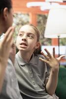 Psychotherapy tackles the growing conflict between a rebellious daughter and mother, as they confront behavioral problems, family issues and stubbornness in an emotional confrontation. photo