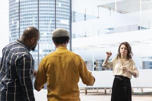 Realtor and business team evaluating workspace design and planning relocation, reviewing blueprints during an office tour. Property investment for startup development. Contract deal. photo