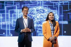 Happy host and expert guest talking at AI summit bringing together tech company employees, exploring latest innovations and discoveries in artificial intelligence industry photo